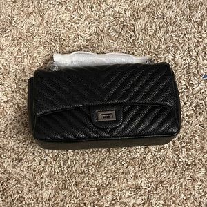 Black faux leather crossbody with metal colored straps